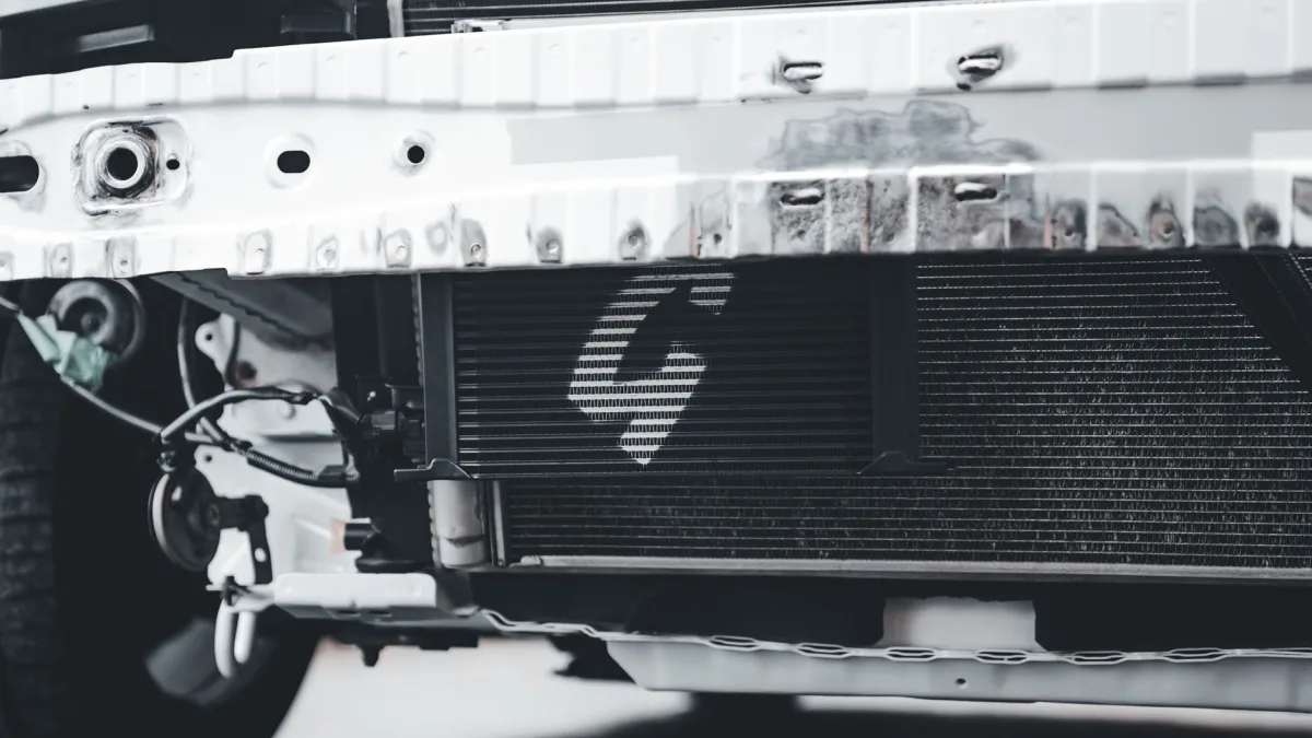 Radar sensor bracket exposed behind a removed front bumper cover