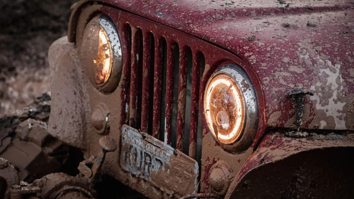 Front grille of a car caked with road grime over the radar area