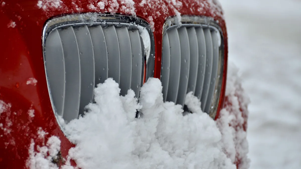 Wet snow packed into a vehicle front grille over the radar sensor