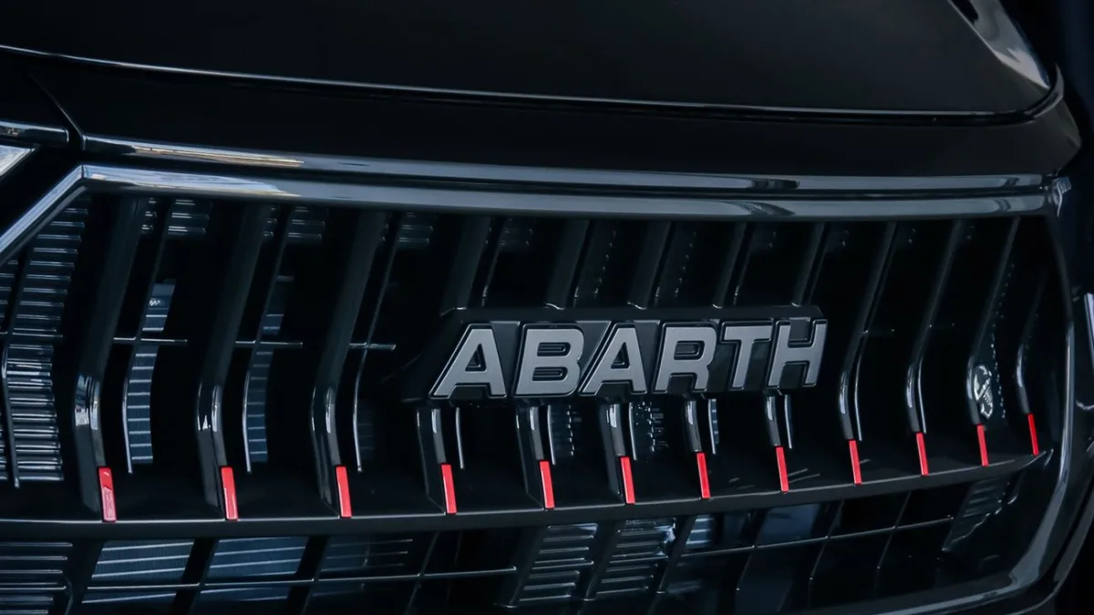 Forward radar sensor hidden behind a vehicle grille badge