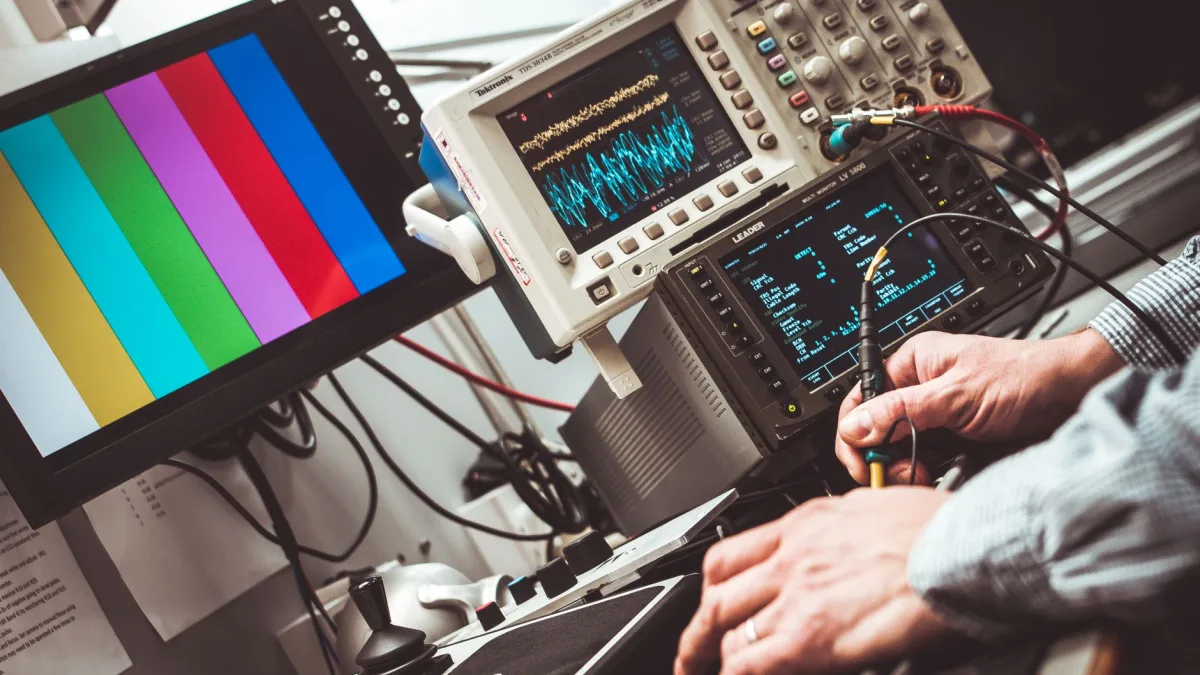 Technician positioning a calibration target board in front of a car