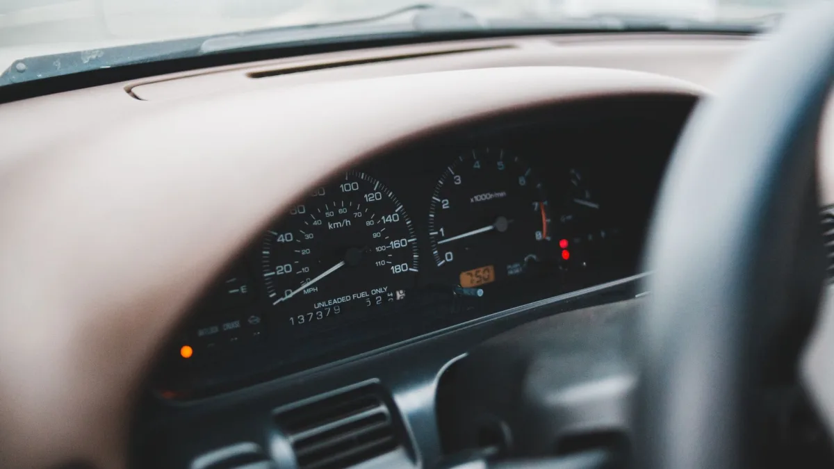 Amber driver assist warning symbol lit on a car instrument cluster