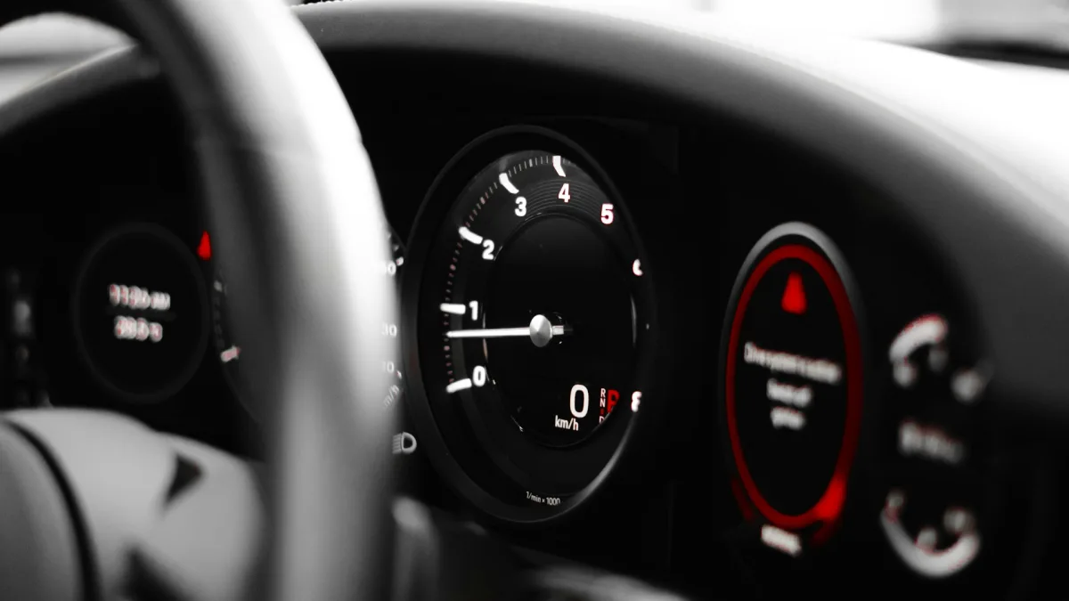 A red collision alert symbol flashing on a vehicle instrument cluster