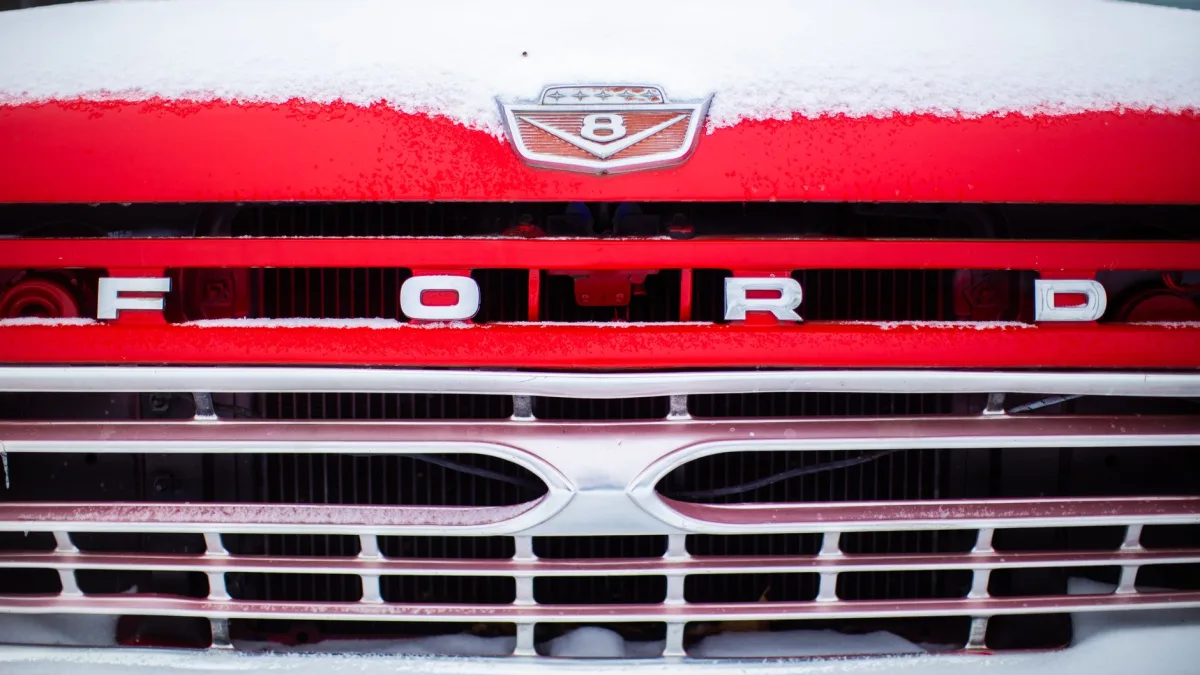 Wet snow caked across a front grille where the collision radar sits