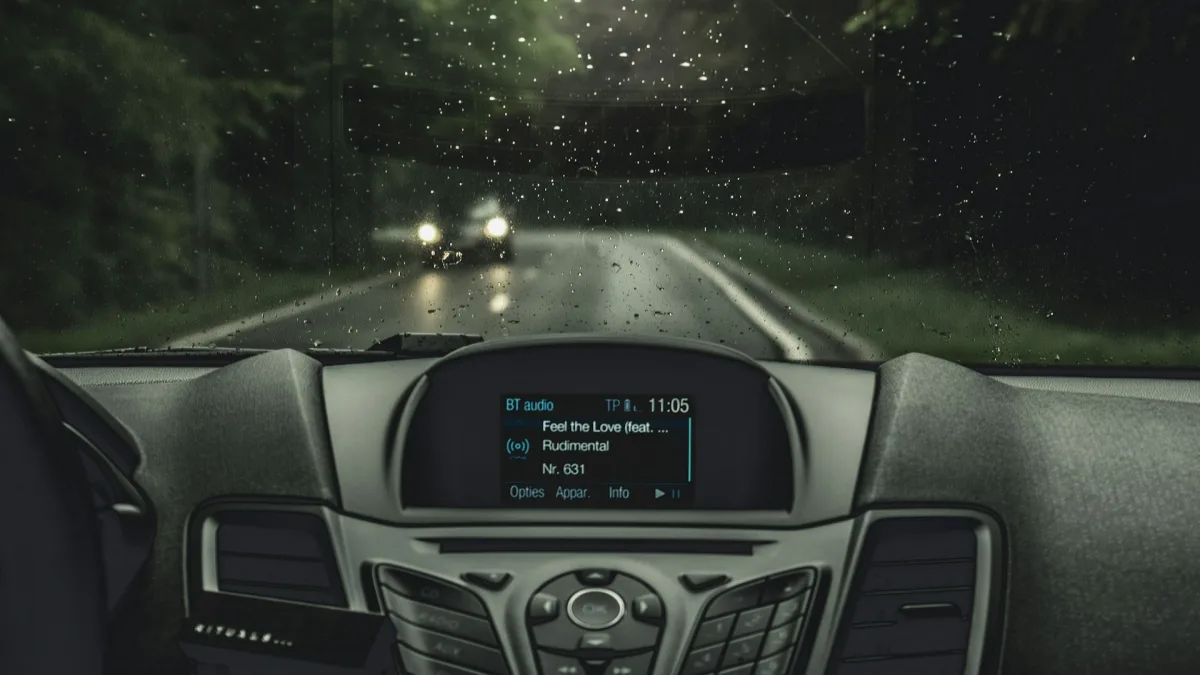 Forward collision warning symbol glowing amber on a vehicle instrument cluster