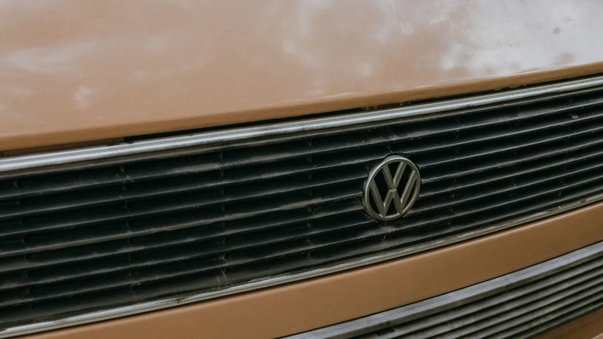 Radar sensor mounted behind a vehicle front grille emblem