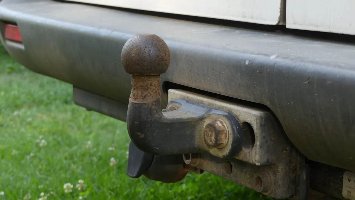 Four bike rack mounted on a rear hitch behind a vehicle bumper