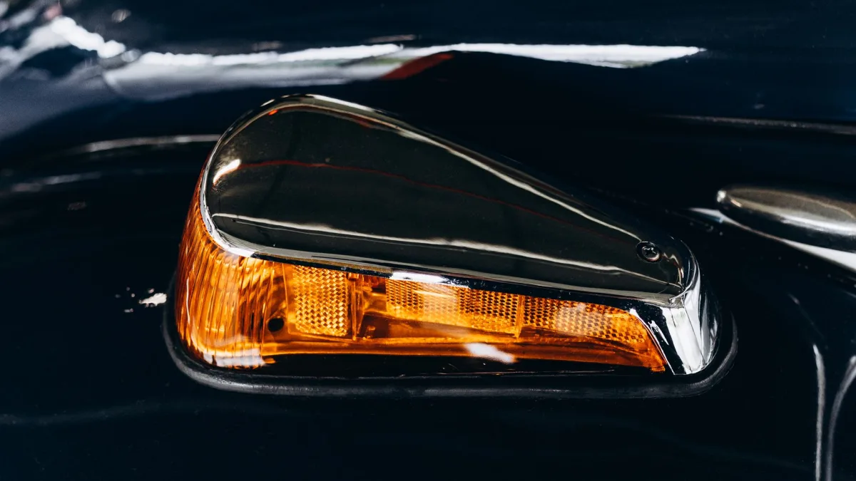 Amber blind spot indicator glowing in a car side mirror