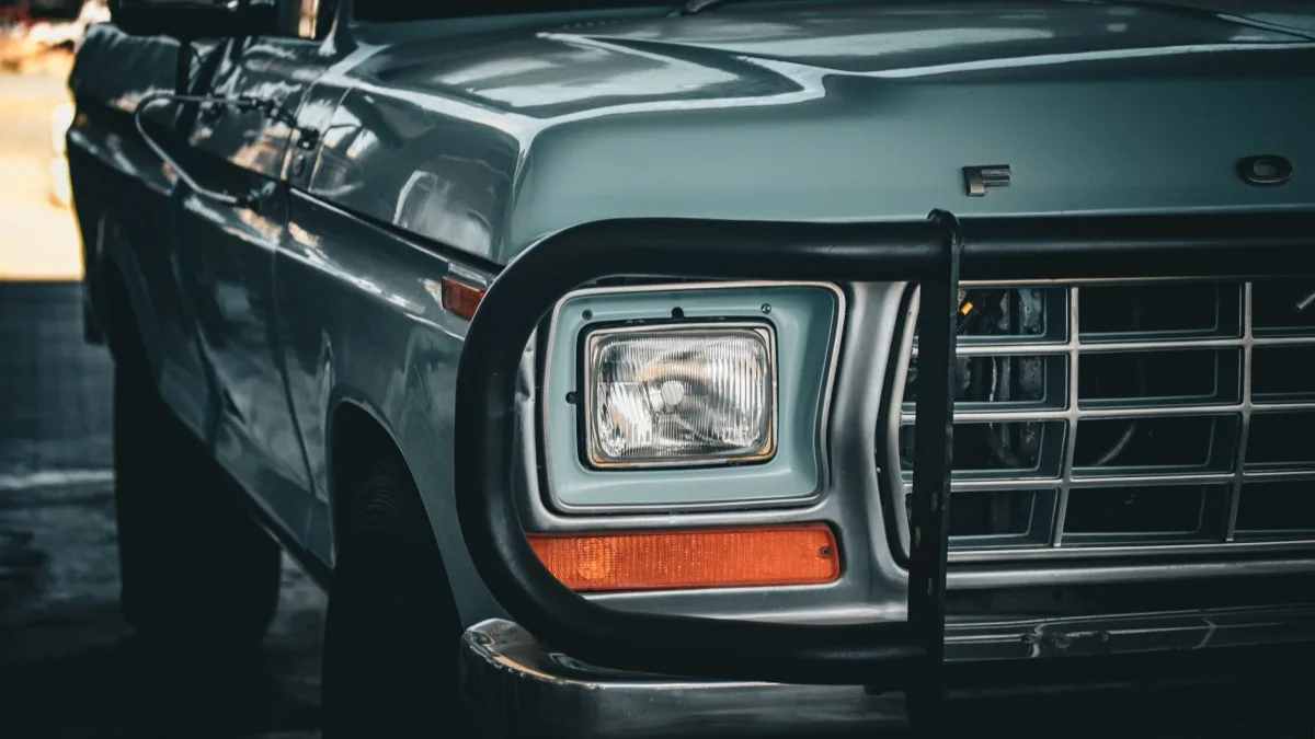 Steel bull bar bolted across the front grille of a pickup truck
