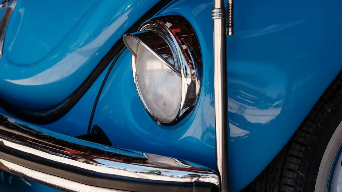 Paint depth gauge held against a repainted rear bumper sensor