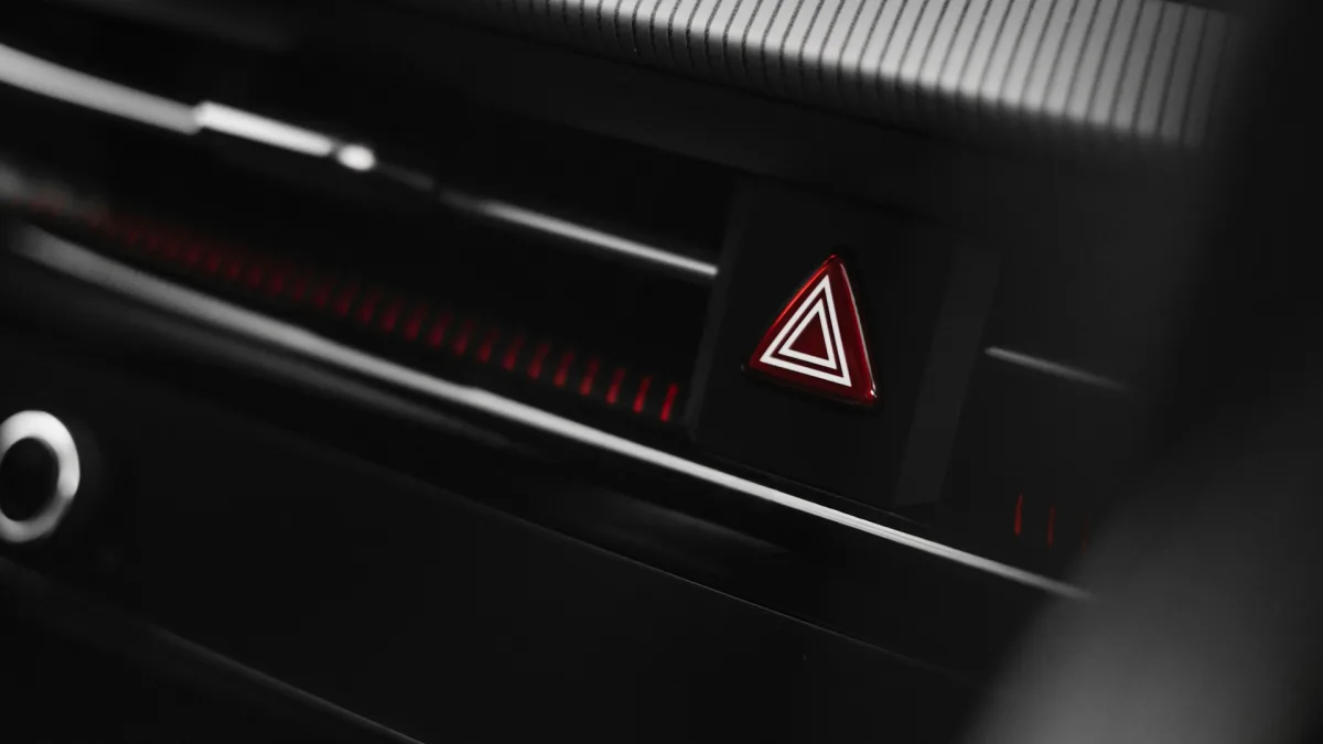 Red forward collision warning symbol flashing on a vehicle instrument cluster