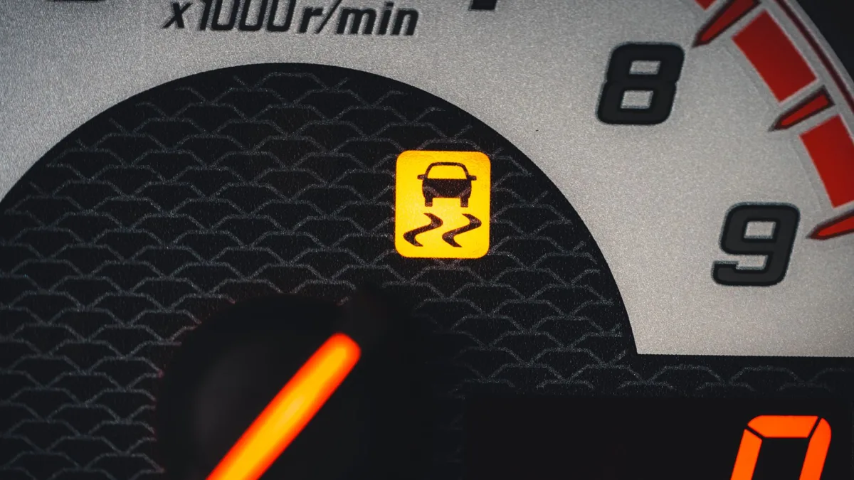 Amber collision warning symbol lit on a Honda instrument cluster