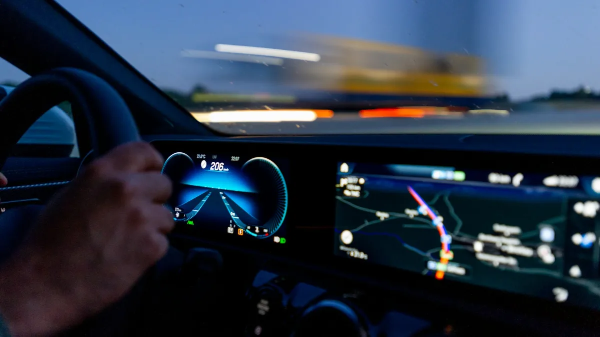 Vehicle speedometer showing highway speed with a lane assist icon lit