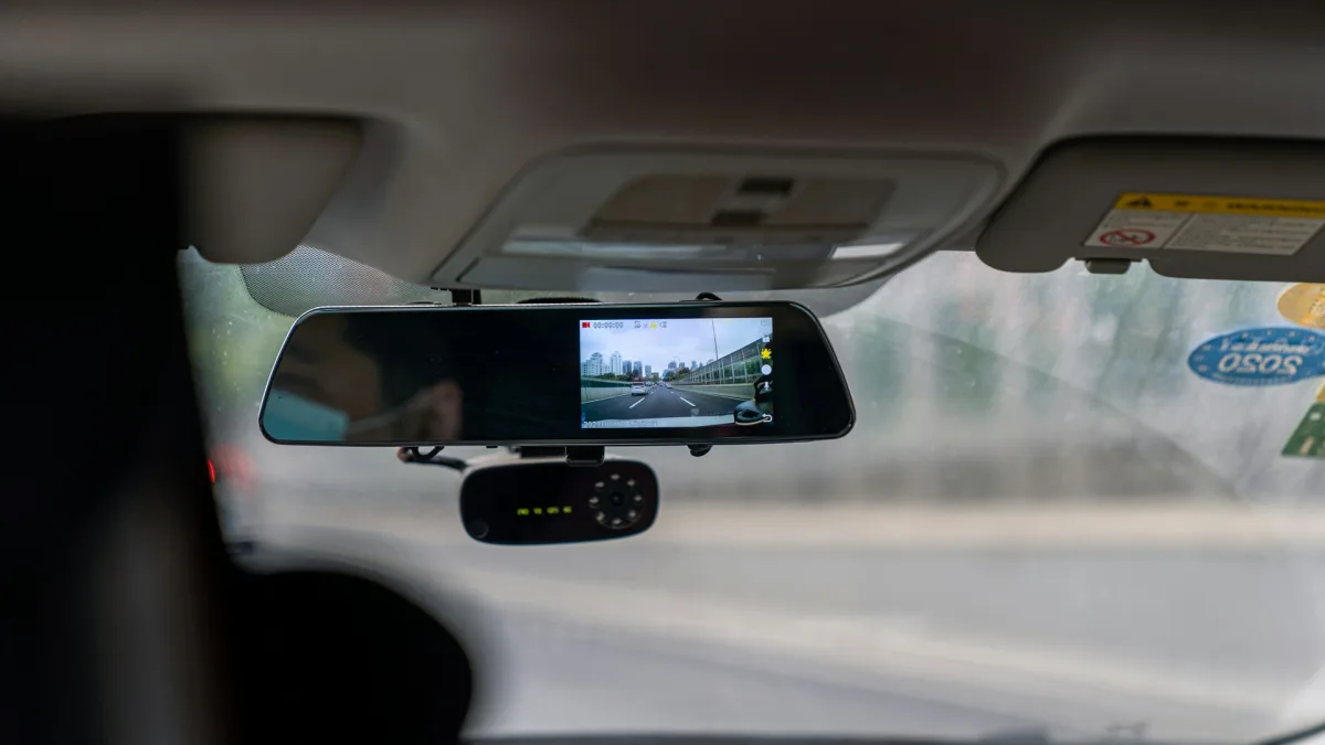 Forward-facing ADAS camera mounted behind a car rearview mirror