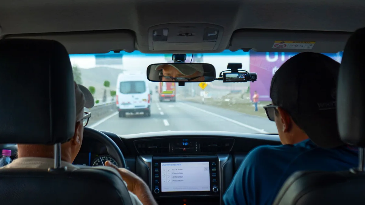 Forward-facing camera module mounted behind a windshield near the rearview mirror