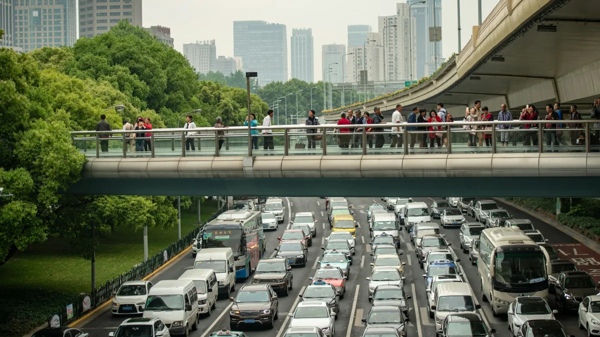 A concrete highway overpass spanning a multi lane road from the driver view