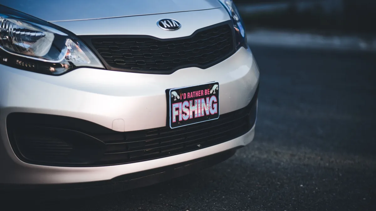 Rear car bumper showing a license plate frame near round parking sensors