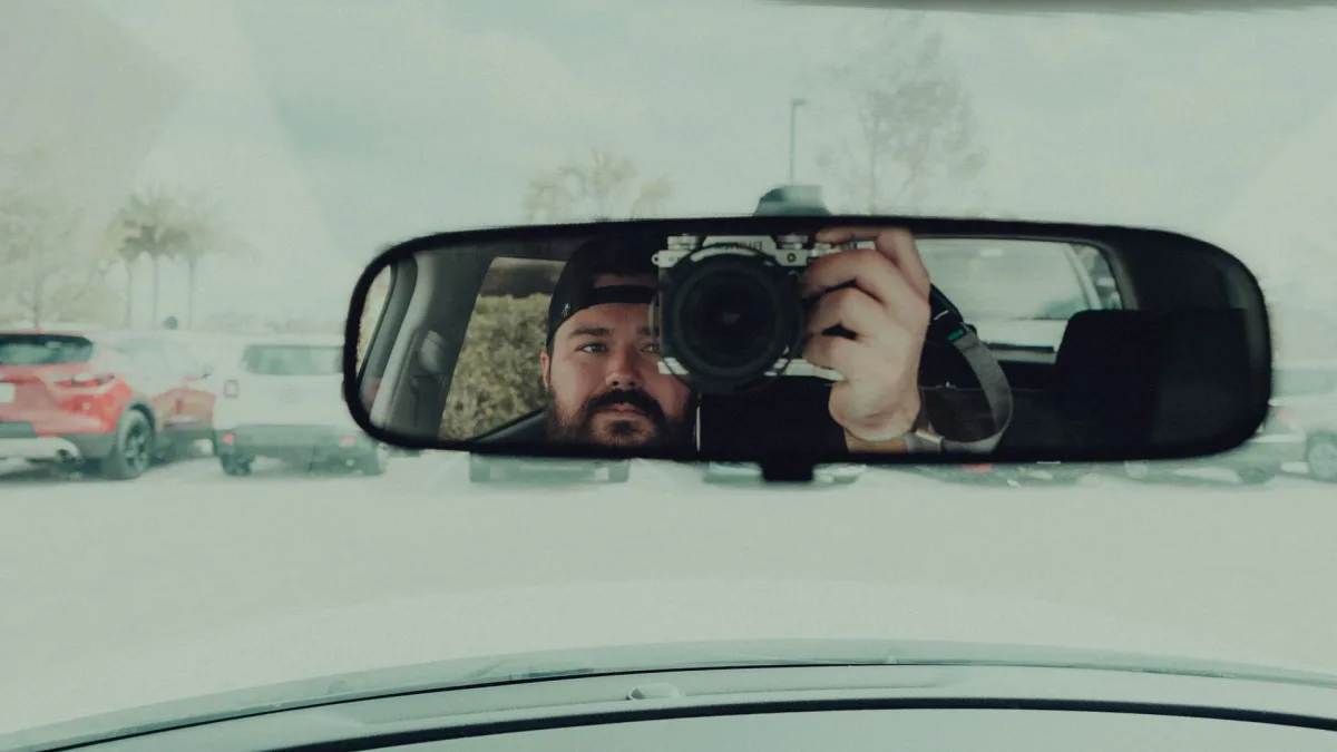 Stereo EyeSight cameras mounted behind a Subaru windshield near the mirror