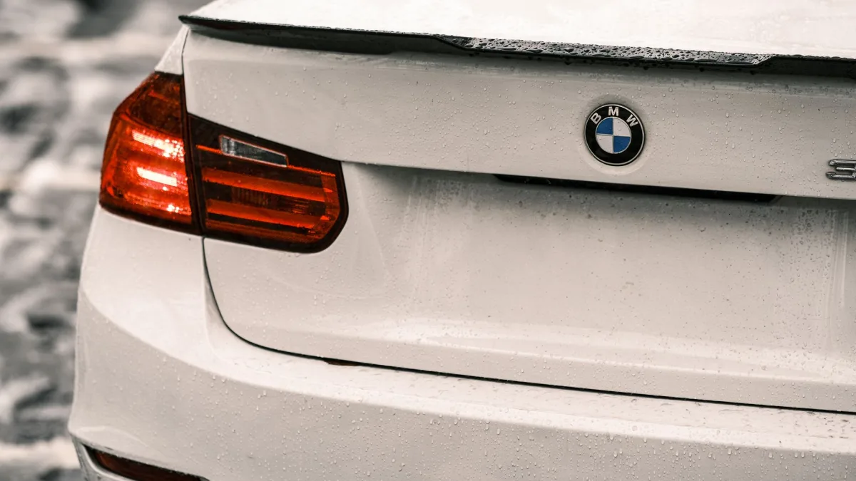 Ice and road salt film crusted over the rear bumper corner where the blind spot radar sits